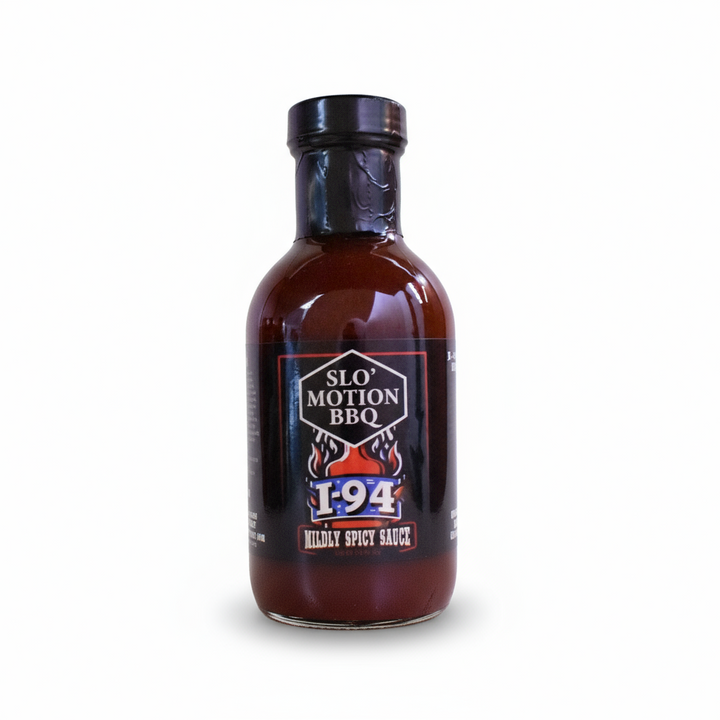 Bottle of Slo' Motion BBQ I-94 Mildly Spicy Sauce with garlic and spices on a red background