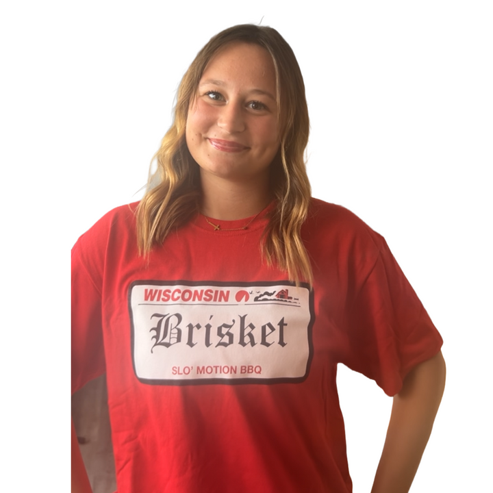 Person wearing a red t-shirt with 'Wisconsin Brisket' text on a white background